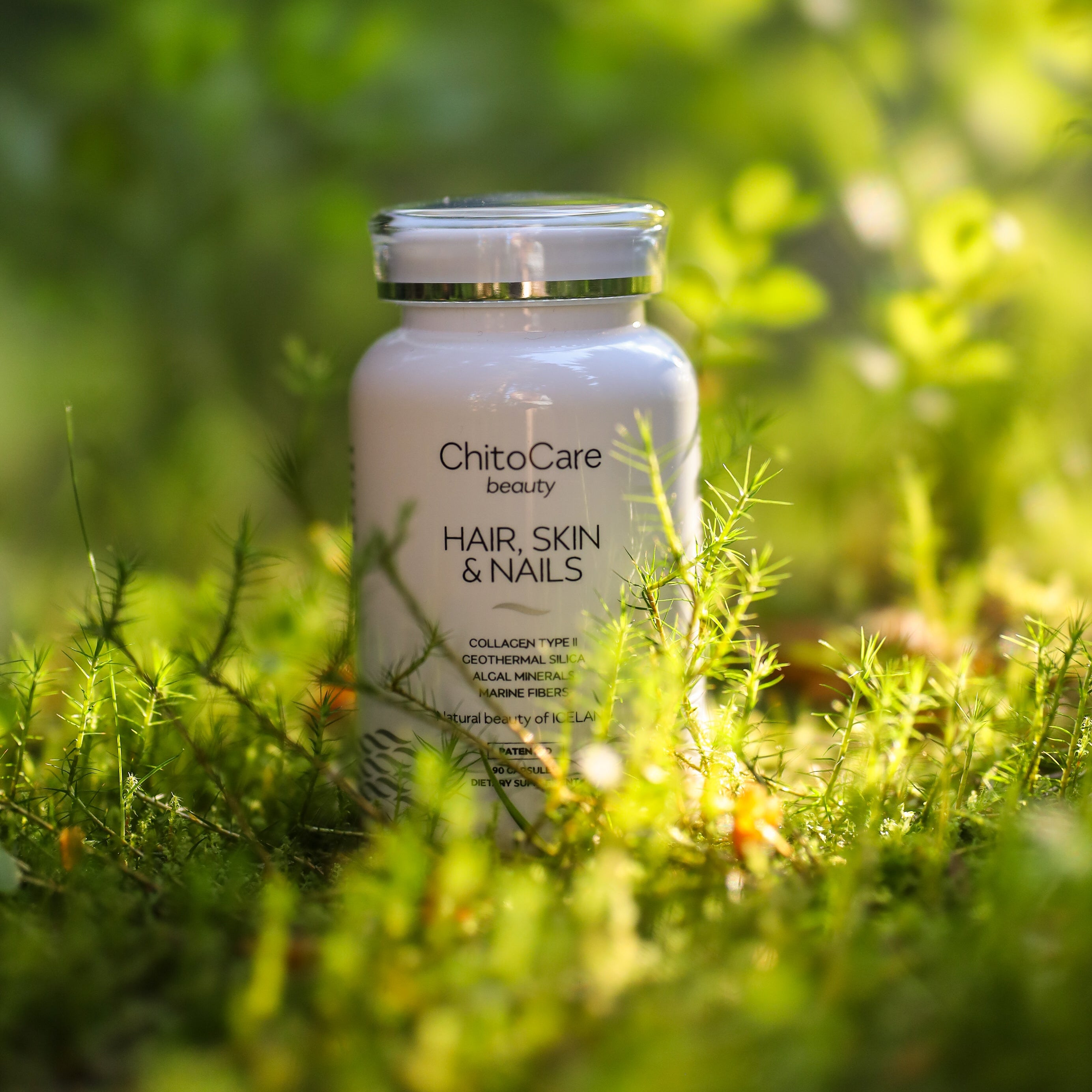 ChitoCare hair, skin, and nails supplement bottle in a grassy field