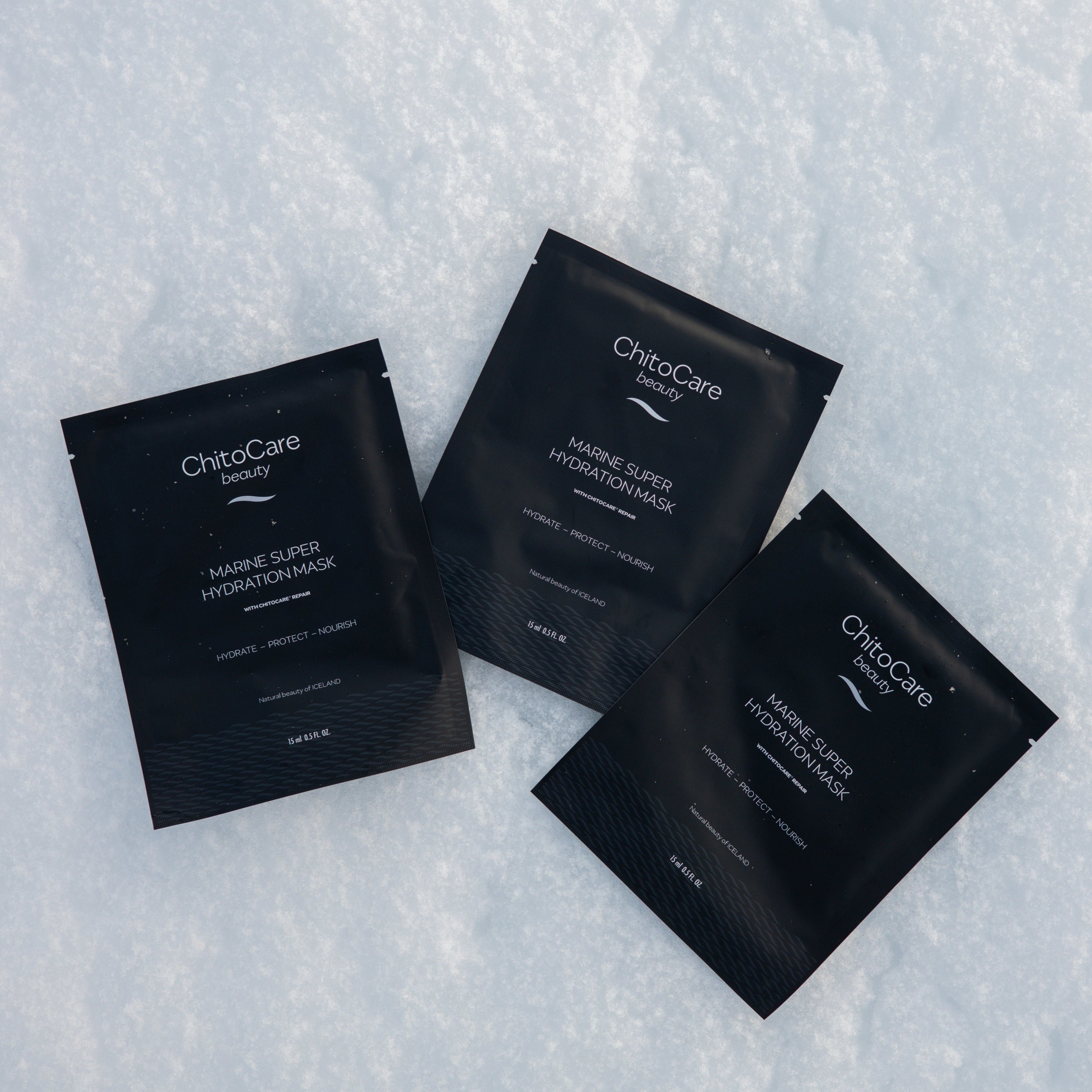 Three sheet masks on a snowy white surface