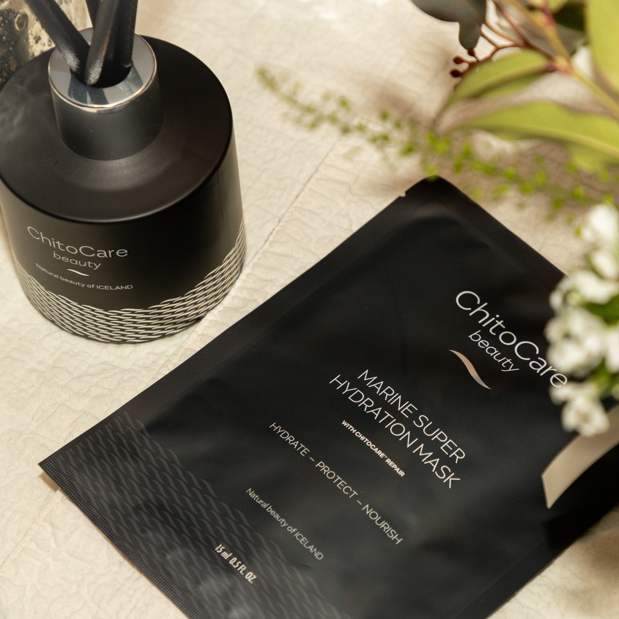 ChitoCare beauty marine super hydration mask on a textured surface with a bottle in the background